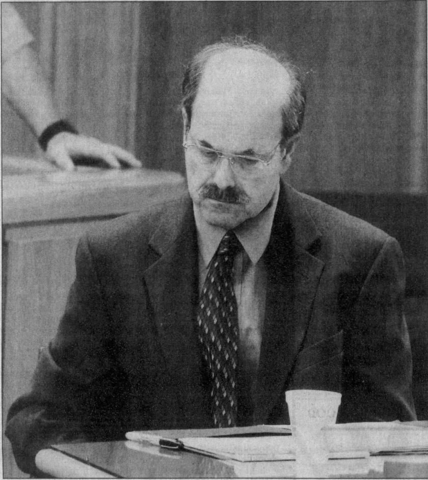 Dennis Rader looking away from his evidence photos