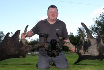 Raymond McElroy with the Antlers and Skulls of an Irish Elk he found in the Northen Ireland.