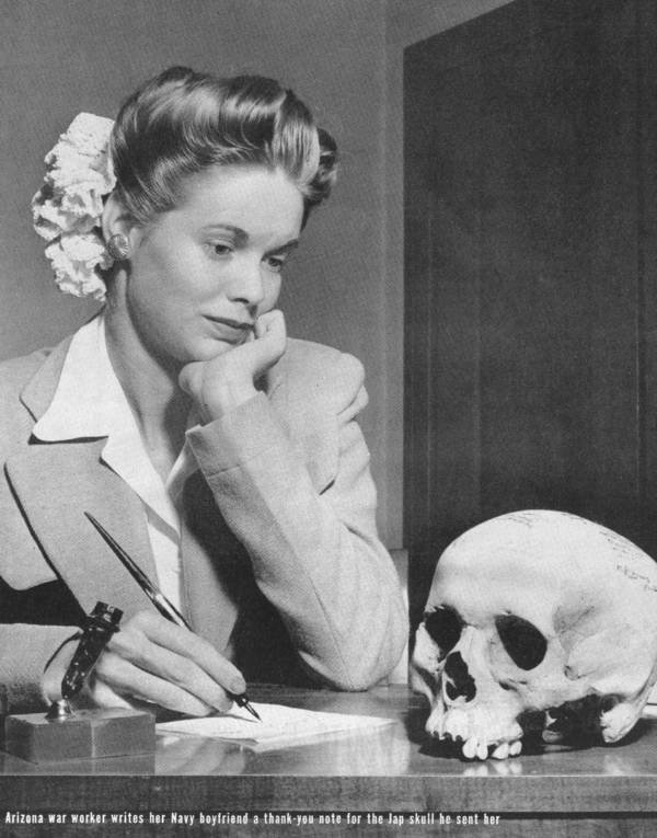 Photo published in the May 22, 1944 issue of LIFE magazine, with the following caption: “When he said goodby two years ago to Natalie Nickerson, 20, a war worker of Phoenix, Arizona, a big, handsome Navy lieutenant promised her a Jap. Last week, Natalie received a human skull, autographed by her lieutenant and 13 friends and inscribed: ‘This is a good Jap-a dead one picked up on the New Guinea beach.’ Natalie, surprised at the gift, named it Tojo. The armed forces disapprove strongly of this sort of thing.”