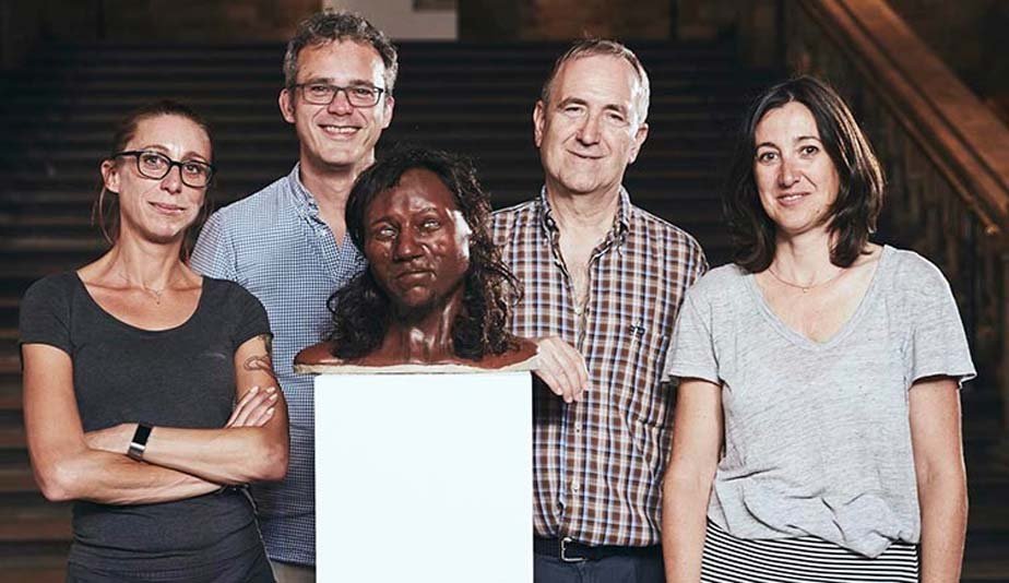 Museum scientists pose with the reconstruction of Cheddar man 